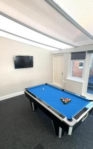 einen Billardtisch in einem Zimmer mit einem TV in der Unterkunft Cheerful Two Bed Home, Free Parking & Pool Table in Middlesbrough