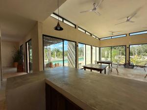 a kitchen with a large counter top in a room with windows at Xbalche eco hotel & RV park 