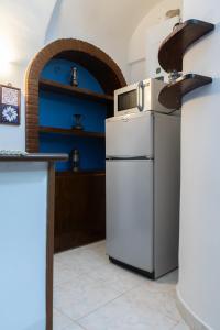 a kitchen with a white refrigerator and an oven at Casa Vitelli - Centro Storico a due passi da tutto in Terracina