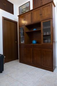 a large wooden cabinet in a room with a door at Casa Vitelli - Centro Storico a due passi da tutto in Terracina