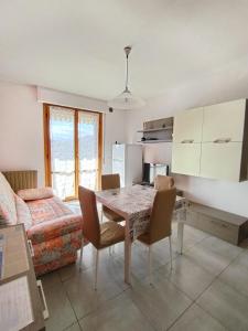 a kitchen and dining room with a table and a couch at Casa Agave in Ventimiglia