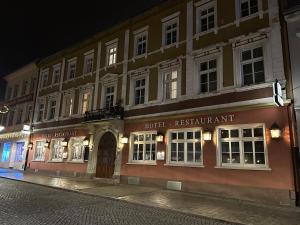 a row of buildings on a street at night at Hotel Sachsenhof in Riesa