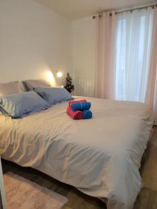 a stuffed animal sitting on top of a bed at Amazing apartment a stone's throw from the City of Lights - Paris in Clichy