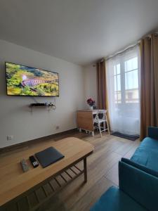 a living room with a couch and a table at Amazing apartment a stone's throw from the City of Lights - Paris in Clichy