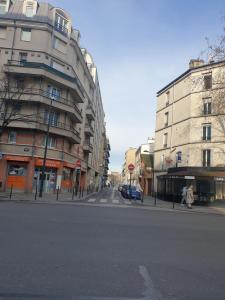 an empty street in a city with buildings at Amazing apartment a stone's throw from the City of Lights - Paris in Clichy