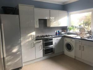 a kitchen with a refrigerator and a stove top oven at Spacious 5 Large Bedroom Victorian House - Beach 2 Miles in Parkstone +59 photos