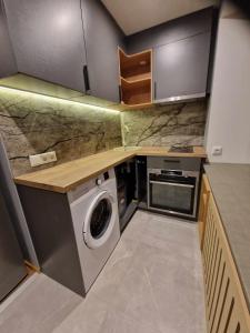 a small kitchen with a washing machine in it at Sofi Apartment in Võru +7 photos