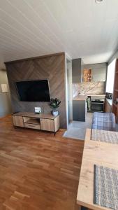 a living room with a large flat screen tv at Sofi Apartment in Võru