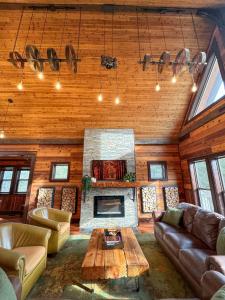 a living room with a couch and a fireplace at Lake Tower Lodge in New Rome