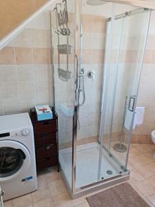 a shower in a bathroom with a washing machine at Antica Domus in Raiano