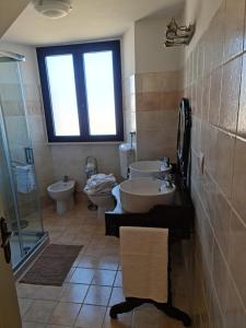 a bathroom with two sinks and two toilets at Antica Domus in Raiano