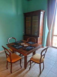 a wooden table with two chairs and a wooden cabinet at Antica Domus in Raiano +11 photos