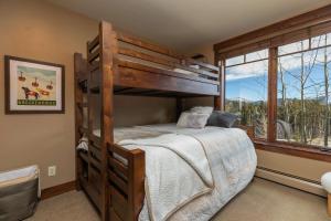 a bedroom with a bunk bed and a window at Crystal Peak Expedition Condo: Ski-In, Ski-Out Luxury in Breckenridge +30 photos