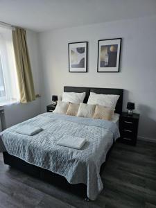 a bedroom with a bed with two pillows on it at Chris Home - Mönchengladbach Minto in Mönchengladbach +35 photos
