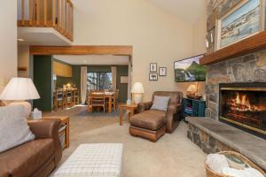 a living room with a fireplace and a couch and chairs at Frisco Mountainside Retreat: Walk Downtown in Frisco