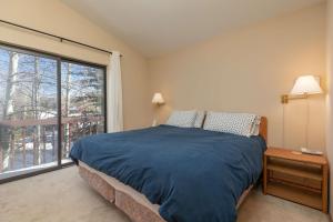 a bedroom with a bed and a large window at Frisco Mountainside Retreat: Walk Downtown in Frisco +38 photos
