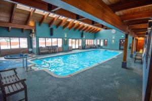 a large swimming pool in a building with a large pool at Frisco Mountainside Retreat: Walk Downtown in Frisco