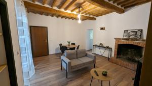 a living room with a couch and a fireplace at Civico 14 in Umbertide