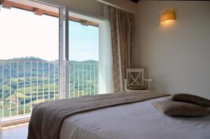 a bedroom with a bed and a large window at CRICHELON in Altavilla Vicentina