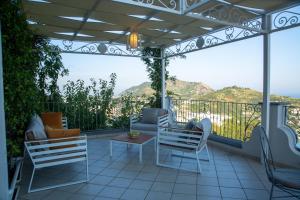 a screened in porch with chairs and a table at A DREAM ISCHIA RESORT in Ischia