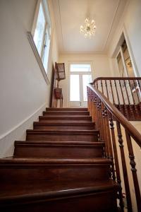 a set of stairs in a house with a chandelier at 1906 Citygarden in Chios