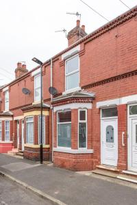 a row of brick buildings on a street at The Urban Apartment in Doncaster