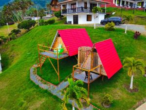 an aerial view of a house with a house with a roof at CABAÑAS SALOME LAGO CALIMA in Calima