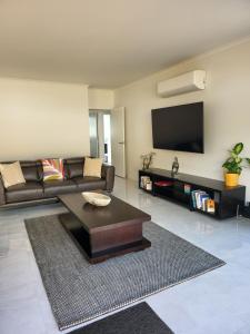 a living room with a couch and a coffee table at Downtown Whakatane in Whakatane