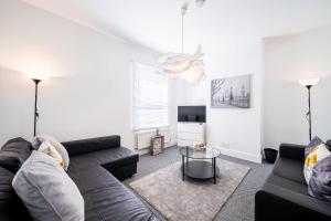 a living room with a couch and a table at The Urban Apartment in Doncaster