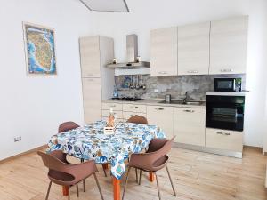 a kitchen with a dining room table with chairs at Casa Vergara Piazza Mazzini in Lecce