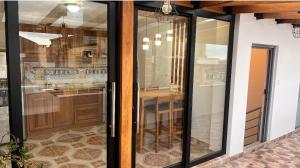 a kitchen with sliding glass doors and a counter at Kimsa Wasi II in Otavalo