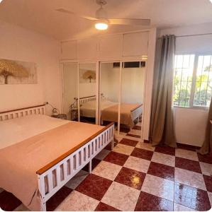 a bedroom with a large bed and a window at Villa Flores Mijas Fuengirola in Santa Fe de los Boliches