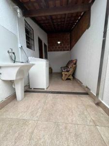 a bathroom with a sink and a toilet in a room at Condomínio Costa Azul in Caraguatatuba