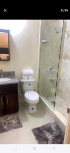 a bathroom with a toilet and a glass shower at Royal Palms Luxury Villas in Ocho Rios