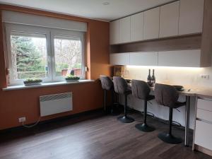 a kitchen with a table with chairs and a window at The Cottage in Murska Sobota