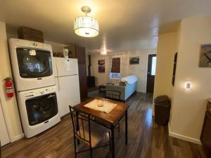 a room with a kitchen with a table and a washer at Zootown Bungalow in Missoula