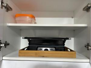 a small stove in the middle of a refrigerator at alisios loft in Las Palmas de Gran Canaria