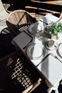 uma mesa com pratos brancos e utensílios em voco Royalty Puebla Downtown em Puebla