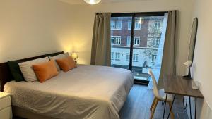 a bedroom with a bed and a desk and a window at Hemel Hives in Hemel Hempstead