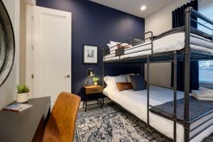 a bedroom with two bunk beds and a desk at New Lux Townhome 6 mins to DT Rooftop Sleeps 12 in Nashville