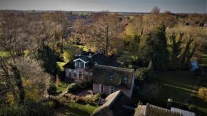 an aerial view of a house in a field at De Consistorie in Giethoorn