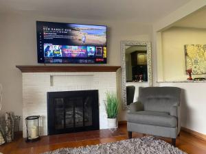 a living room with a television above a fireplace at 4 Bedrooms~2 Baths Cute & Cozy, Excellent Location in Dubuque