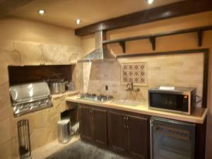 a kitchen with a sink and a microwave at Junior Suite in Los Gatos