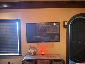 a room with a tv and a table and a window at Junior Suite in Los Gatos