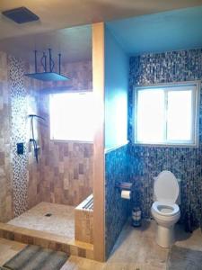 a bathroom with a toilet and a shower and a window at Junior Suite in Los Gatos