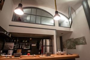 a dining room with two lights hanging over a table at FERIEN-LOFT in Heidenau