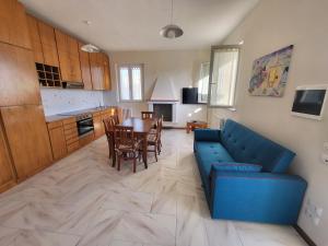 - un salon avec un canapé bleu et une table dans l'établissement Appartamento - Porto San Giorgio, à Porto San Giorgio