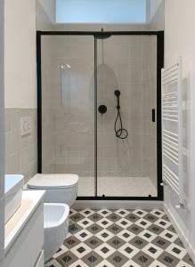 a bathroom with a shower and a toilet at Noliday Savona Center Art Deco Apartment in Savona