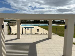 a view of a swimming pool from a patio at New penthouse with sunny beach view in Huelva