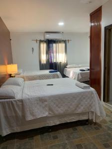 a hotel room with two beds in a room at Complejo Deportivo Wilson Palacios in El Perú